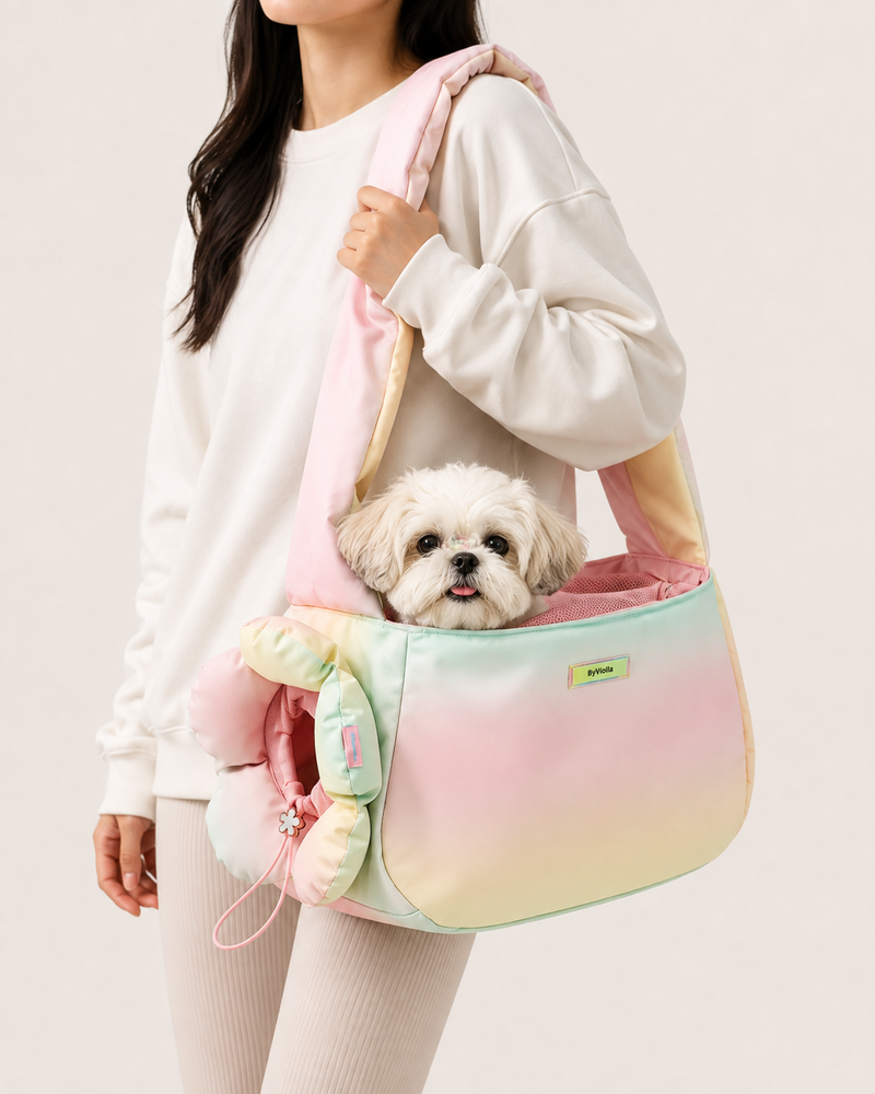 Small dog sitting inside pastel flower pet carrier bag worn over the shoulder