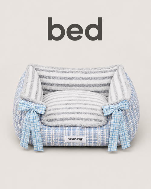 Blue tweed pet bed with plush striped interior and blue plaid bow accents