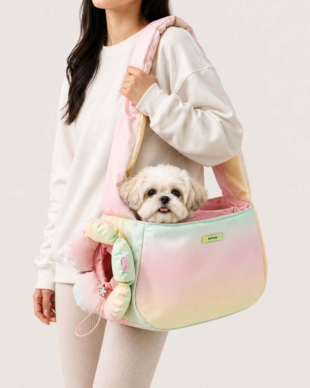 Small dog sitting inside pastel flower pet carrier bag worn over the shoulder