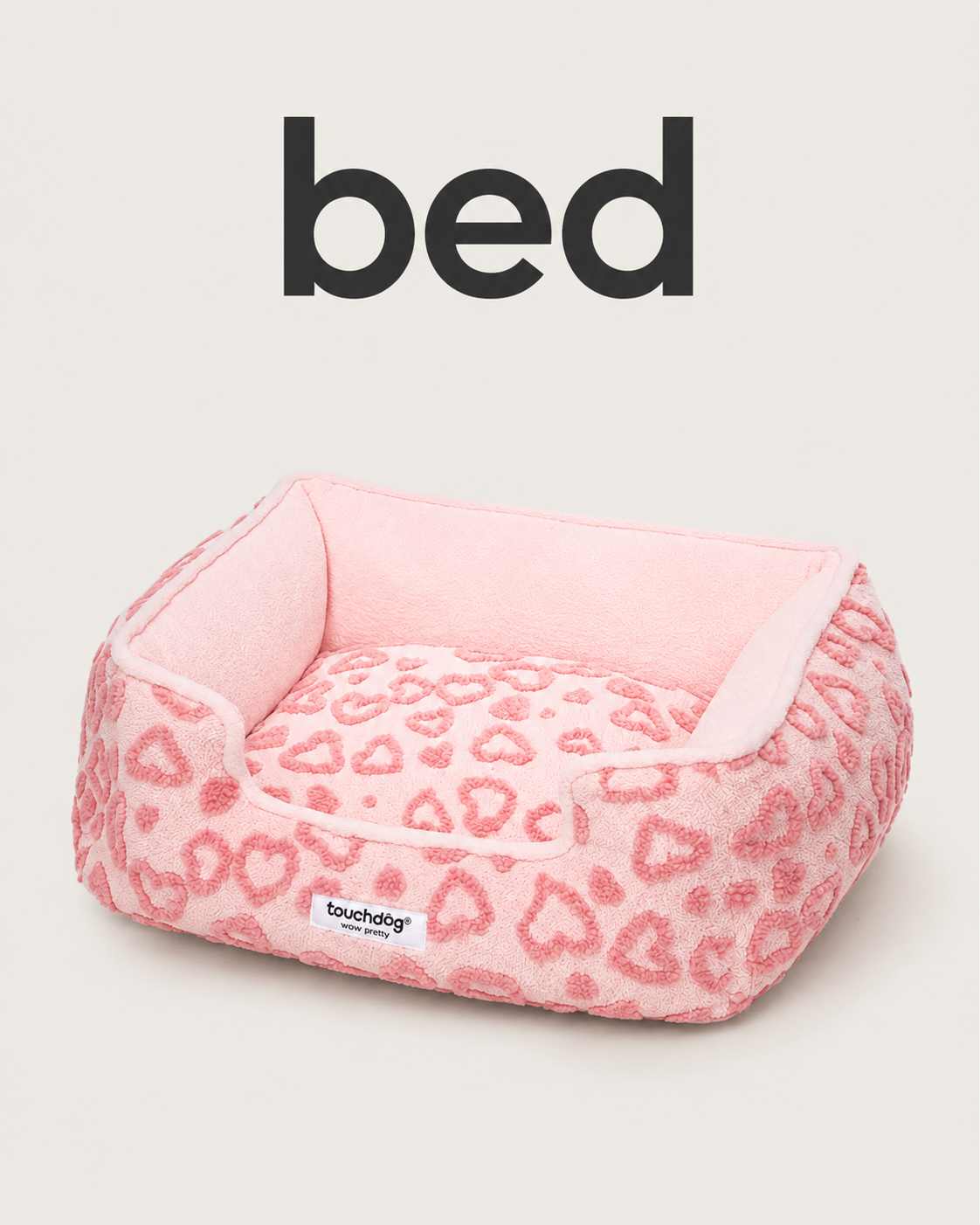 Pink plush pet bed with raised sides and heart pattern